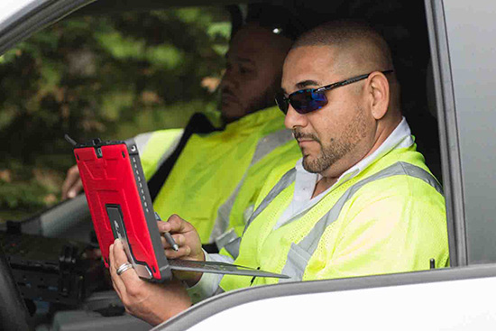 Man using laptop in car